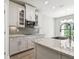 Stylish kitchen with stainless steel appliances, gray backsplash, countertops, and shaker style cabinets at 620 Nasturtium Ct, Nokomis, FL 34275