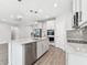 Well-equipped kitchen with stainless steel appliances, an island, and an adjacent living area at 620 Nasturtium Ct, Nokomis, FL 34275