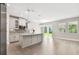 Bright kitchen with an island, stainless steel appliances, shaker cabinets, and sliding glass doors to the backyard at 620 Nasturtium Ct, Nokomis, FL 34275