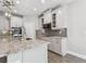 Well-lit kitchen with an island, stainless steel appliances, pendant lighting, and shaker cabinets at 620 Nasturtium Ct, Nokomis, FL 34275