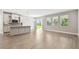 Bright open-concept kitchen and dining area with gray tile flooring, stainless steel appliances and a view of the backyard at 620 Nasturtium Ct, Nokomis, FL 34275