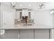 Elegant kitchen with an island, modern lighting, stainless steel appliances, and white cabinetry at 620 Nasturtium Ct, Nokomis, FL 34275
