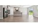 Open-plan kitchen with an island, stainless steel appliances, and an adjoining dining and living area at 620 Nasturtium Ct, Nokomis, FL 34275