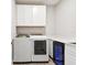 Bright laundry room with white cabinetry, counterspace, and modern washer and dryer units at 620 Nasturtium Ct, Nokomis, FL 34275