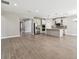 Open-concept living space flows into the kitchen, featuring stainless steel appliances and ample cabinetry at 620 Nasturtium Ct, Nokomis, FL 34275