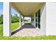 Covered patio with brick flooring, offering a seamless transition between indoor and outdoor living spaces at 620 Nasturtium Ct, Nokomis, FL 34275