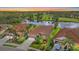 Scenic sunset aerial view of houses on a well-manicured lawn near a lake at 6408 Rookery Cir, Bradenton, FL 34203