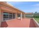 Private covered patio with lovely pond and golf course views through sliding glass doors at 6408 Rookery Cir, Bradenton, FL 34203