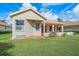 Charming home features a cozy back patio and well-manicured lawn at 6408 Rookery Cir, Bradenton, FL 34203