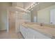 Bright bathroom featuring double sinks, tile floors, and a glass block shower, perfect for a quick rinse at 6408 Rookery Cir, Bradenton, FL 34203