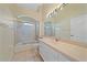 Bright bathroom showcasing a tub, a large mirror with vanity lighting and a neutral color palette at 6408 Rookery Cir, Bradenton, FL 34203