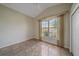 Bedroom features tile floors, neutral walls, and a large window with elegant drapery at 6408 Rookery Cir, Bradenton, FL 34203