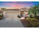 Charming single-story home with lush landscaping and a well-maintained front yard and a two-car garage at 6408 Rookery Cir, Bradenton, FL 34203