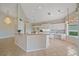 Bright kitchen with white cabinetry, granite counters, and an open layout at 6408 Rookery Cir, Bradenton, FL 34203