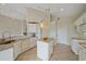 Bright kitchen featuring white cabinets, an island, granite countertops, tile flooring at 6408 Rookery Cir, Bradenton, FL 34203