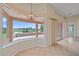 Bright kitchen nook featuring large windows with picturesque lake views at 6408 Rookery Cir, Bradenton, FL 34203