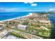 Panoramic aerial view of beachfront condos, blue ocean, and intercoastal waterway on a sunny day at 6415 Midnight Pass Rd # 710, Sarasota, FL 34242