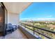 Balcony with chair overlooks lush landscape and cityscape at 6415 Midnight Pass Rd # 710, Sarasota, FL 34242