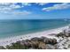 Stunning beach view from a high-rise building with a white sandy beach and turquoise water at 6415 Midnight Pass Rd # 710, Sarasota, FL 34242