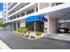 Well-maintained building entrance with covered parking and lush green landscaping, plus a covered entryway at 6415 Midnight Pass Rd # 710, Sarasota, FL 34242