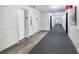 Bright hallway featuring elevators, clean walls, new carpet and flooring, and access to resident doors at 6415 Midnight Pass Rd # 710, Sarasota, FL 34242
