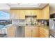 Updated kitchen featuring maple cabinets, granite countertops, and stainless steel dishwasher at 6415 Midnight Pass Rd # 710, Sarasota, FL 34242