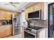 Updated kitchen showcasing stainless steel appliances, granite counters, and maple cabinetry at 6415 Midnight Pass Rd # 710, Sarasota, FL 34242