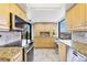 Well-lit kitchen with maple cabinets, granite countertops, and stainless steel appliances at 6415 Midnight Pass Rd # 710, Sarasota, FL 34242