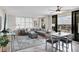 Bright living room featuring comfortable seating, ceiling fan, and access to a private balcony at 6415 Midnight Pass Rd # 710, Sarasota, FL 34242