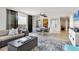 Inviting living room area with a comfortable sofa, dining table, and access to the balcony at 6415 Midnight Pass Rd # 710, Sarasota, FL 34242