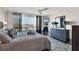 Comfortable main bedroom with balcony access, TV, and dresser at 6415 Midnight Pass Rd # 710, Sarasota, FL 34242