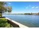 Picturesque view of boats sailing along calm blue waters from a waterfront property with benches at 6415 Midnight Pass Rd # 710, Sarasota, FL 34242