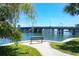 Scenic waterfront view with a bench overlooking the blue water and bridge in the background at 6415 Midnight Pass Rd # 710, Sarasota, FL 34242