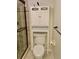 Bathroom with a toilet, shower, grab bars, and a cabinet above the toilet at 6430 Sun Eagle Ln # 203, Bradenton, FL 34210