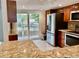 Bright kitchen with stainless steel appliances, granite counters, and sliding door access to patio at 6430 Sun Eagle Ln # 203, Bradenton, FL 34210