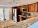 Modern kitchen featuring stainless steel appliances and granite countertops at 6430 Sun Eagle Ln # 203, Bradenton, FL 34210