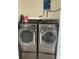 Modern laundry area featuring front-load washer and dryer with above-shelf storage at 6430 Sun Eagle Ln # 203, Bradenton, FL 34210