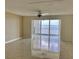 Bright living room with tile flooring and a sliding glass door with water views at 6430 Sun Eagle Ln # 203, Bradenton, FL 34210