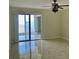 Bright living room with sliding doors, tile flooring, and water views at 6430 Sun Eagle Ln # 203, Bradenton, FL 34210