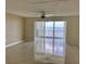 Bright living room with tile floors and sliding doors offering stunning water views at 6430 Sun Eagle Ln # 203, Bradenton, FL 34210