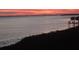 Scenic sunset view over the water with vibrant orange and pink hues painting the sky, reflecting on the tranquil surface at 6430 Sun Eagle Ln # 203, Bradenton, FL 34210