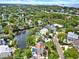 An aerial view of a waterfront neighborhood features stunning homes and beautiful landscaping near serene waterways at 748 Soundview Dr, Palm Harbor, FL 34683