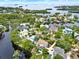 An aerial shot shows a picturesque neighborhood, showcasing luxurious waterfront homes with lush greenery and serene waterways at 748 Soundview Dr, Palm Harbor, FL 34683