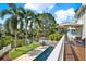 Aerial view of a backyard featuring a pool, outdoor seating, and lush landscaping at 748 Soundview Dr, Palm Harbor, FL 34683