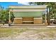 Outdoor amphitheater stage with a covered roof, and neutral tones surrounded by green space and trees at 748 Soundview Dr, Palm Harbor, FL 34683