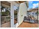 Back deck with chairs and table, wood floors, and featuring access to backyard patio and pool at 748 Soundview Dr, Palm Harbor, FL 34683