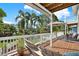 Relaxing back deck with wood floors, outdoor furniture, and views of the landscaped backyard at 748 Soundview Dr, Palm Harbor, FL 34683