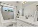 Bright bathroom featuring vanity with sink, with a shower and toilet next to window and towel rack at 748 Soundview Dr, Palm Harbor, FL 34683