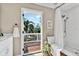 Bathroom with a shower and toilet with a view out to the deck through a screened door at 748 Soundview Dr, Palm Harbor, FL 34683