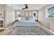 Bright bedroom featuring neutral walls, wood floors, ceiling fan, and plenty of natural light from multiple windows at 748 Soundview Dr, Palm Harbor, FL 34683